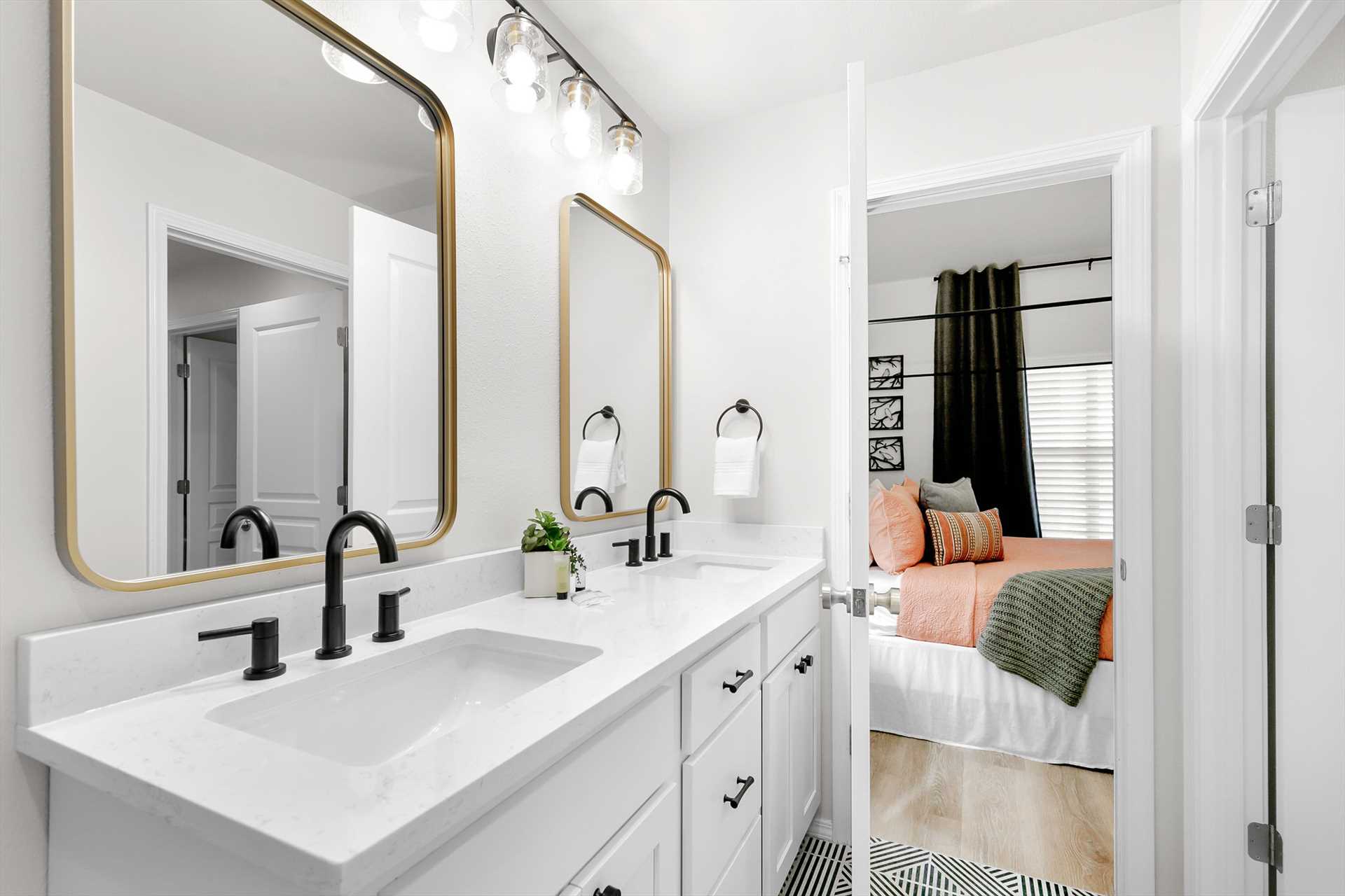 This bedroom also has a connected bathroom with double sinks