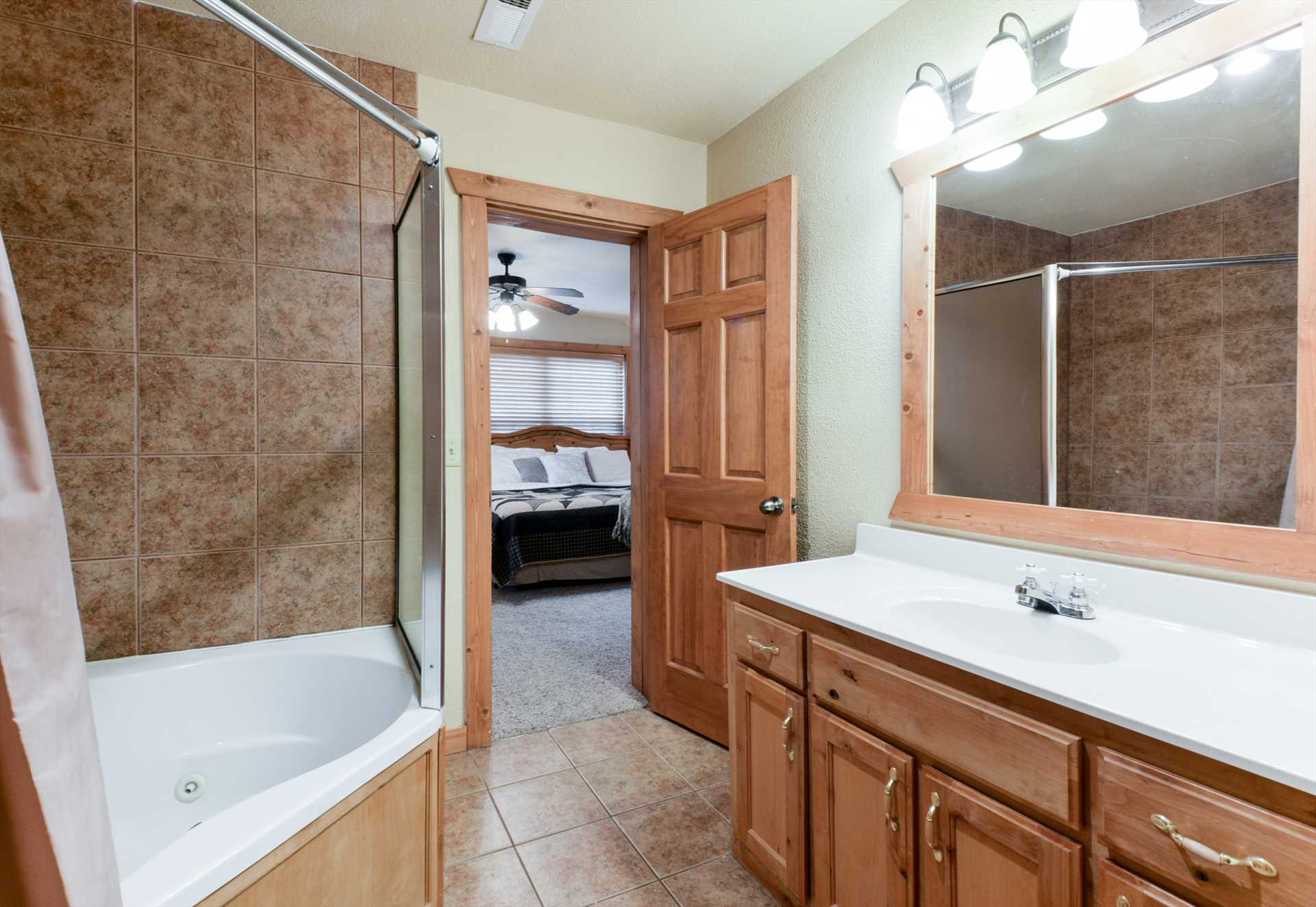 Both upstairs bathrooms include a large jetted tub/ shower c