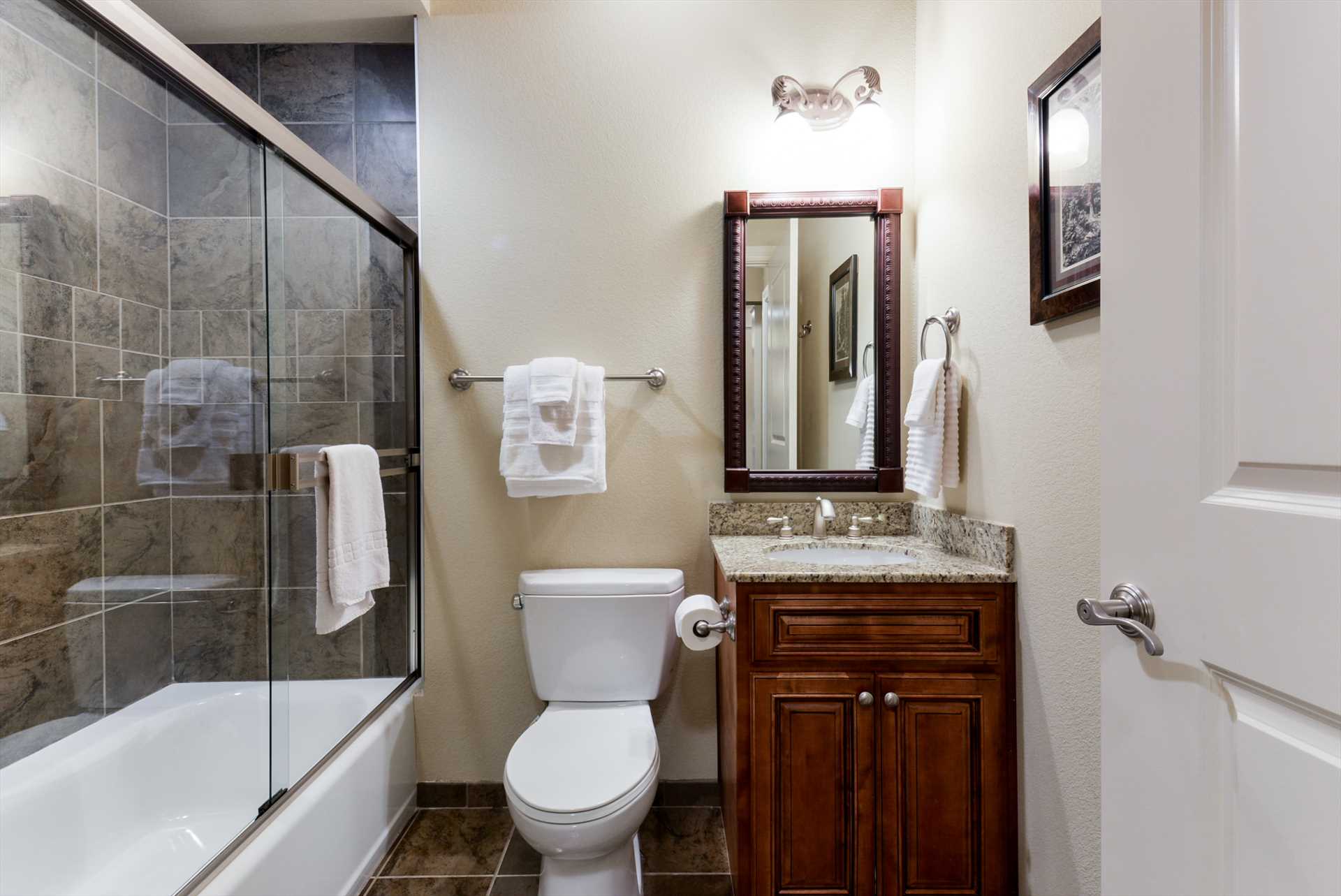 This bathroom includes a combination shower/tub.