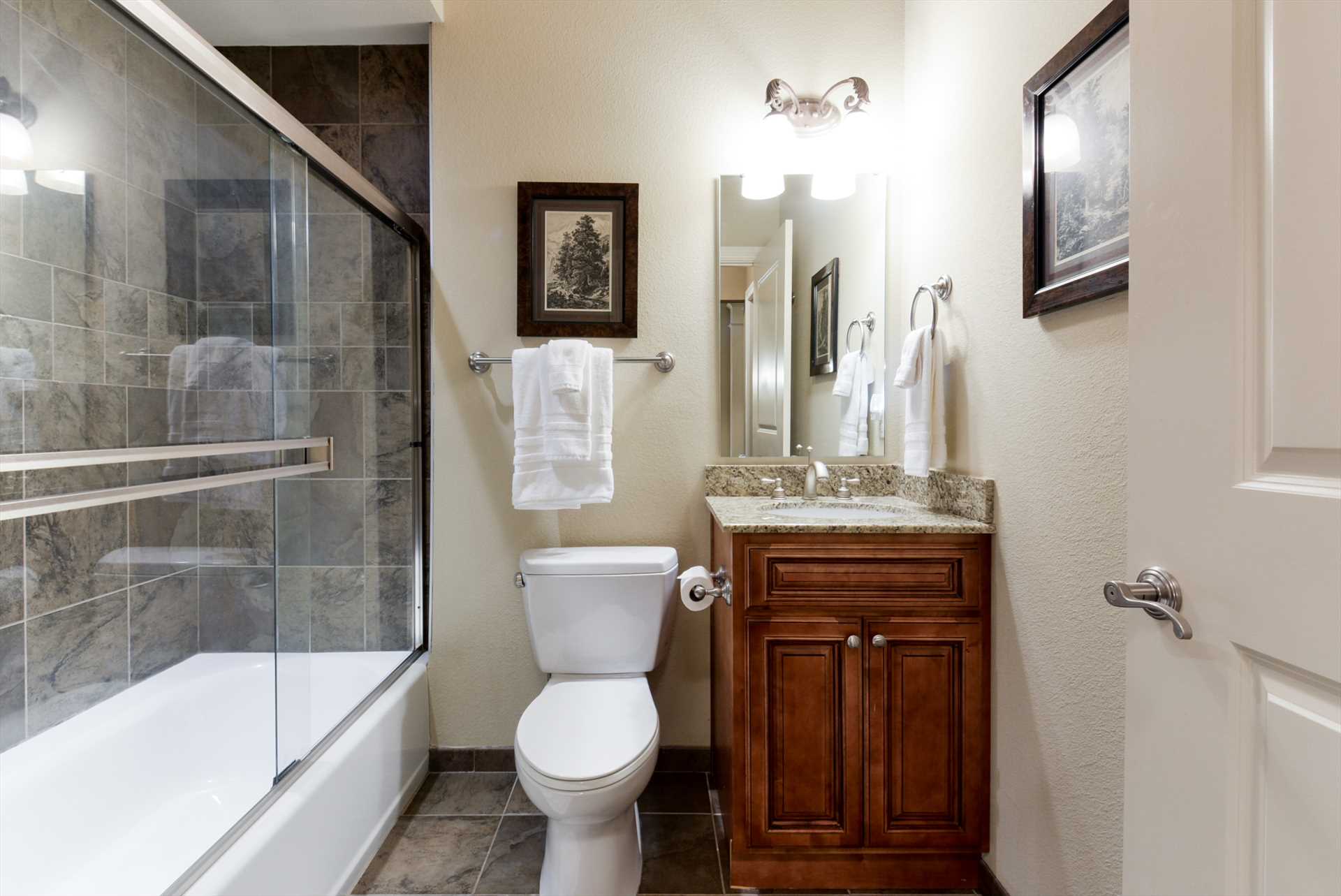 This bathroom includes a combination shower/tub.