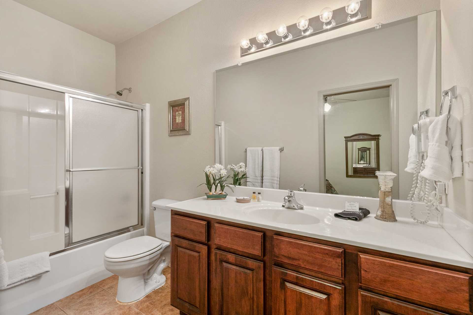 This bathroom has a shower/ tub combo.