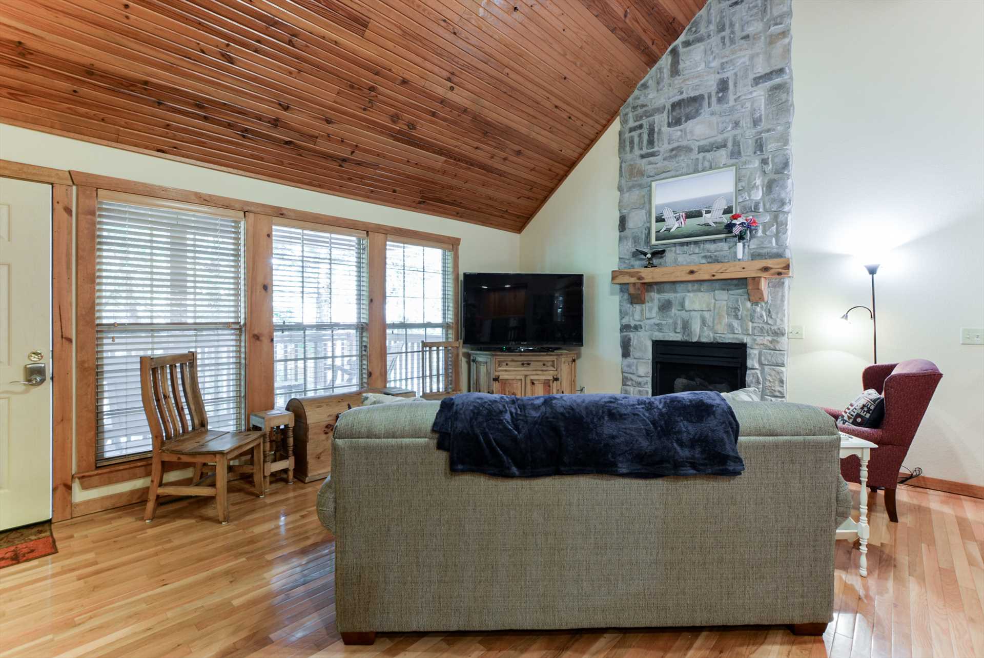 The stone fireplace is the centerpiece of the living area.