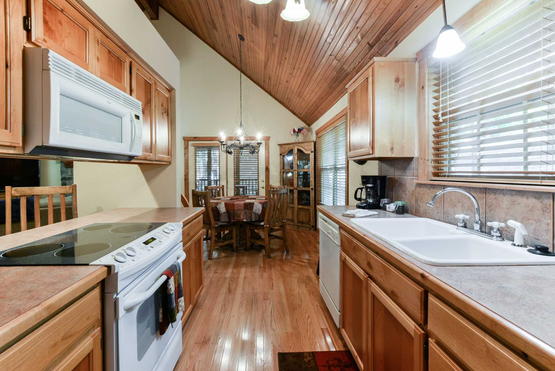 The kitchen is open to the dining area and mail living room.