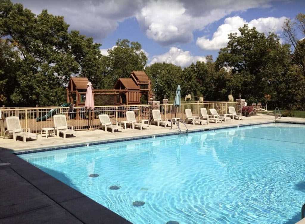 The seasonal outdoor pool has two waterslides and a hot tub.