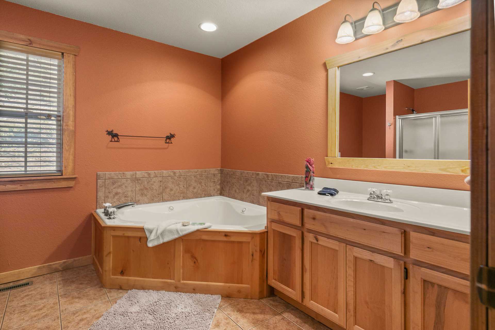 This bathroom includes a large whirlpool tub and walk-in sho