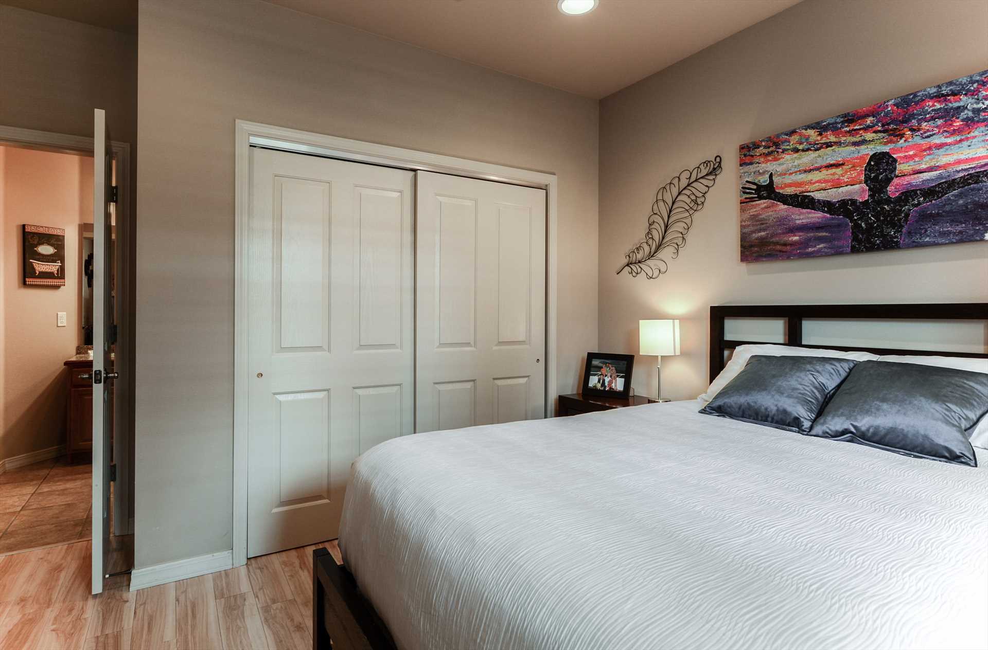 Unique art and a large closet complete this bedroom.