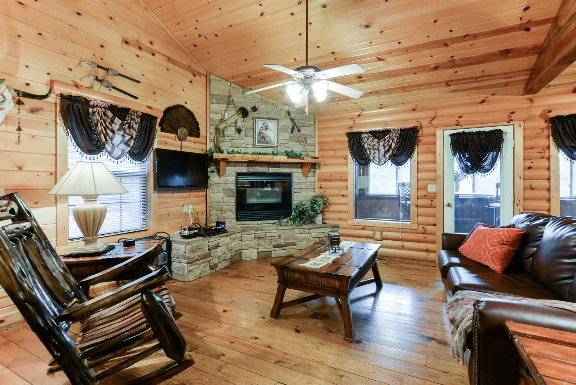 The stone fireplace is the centerpiece of the living area.