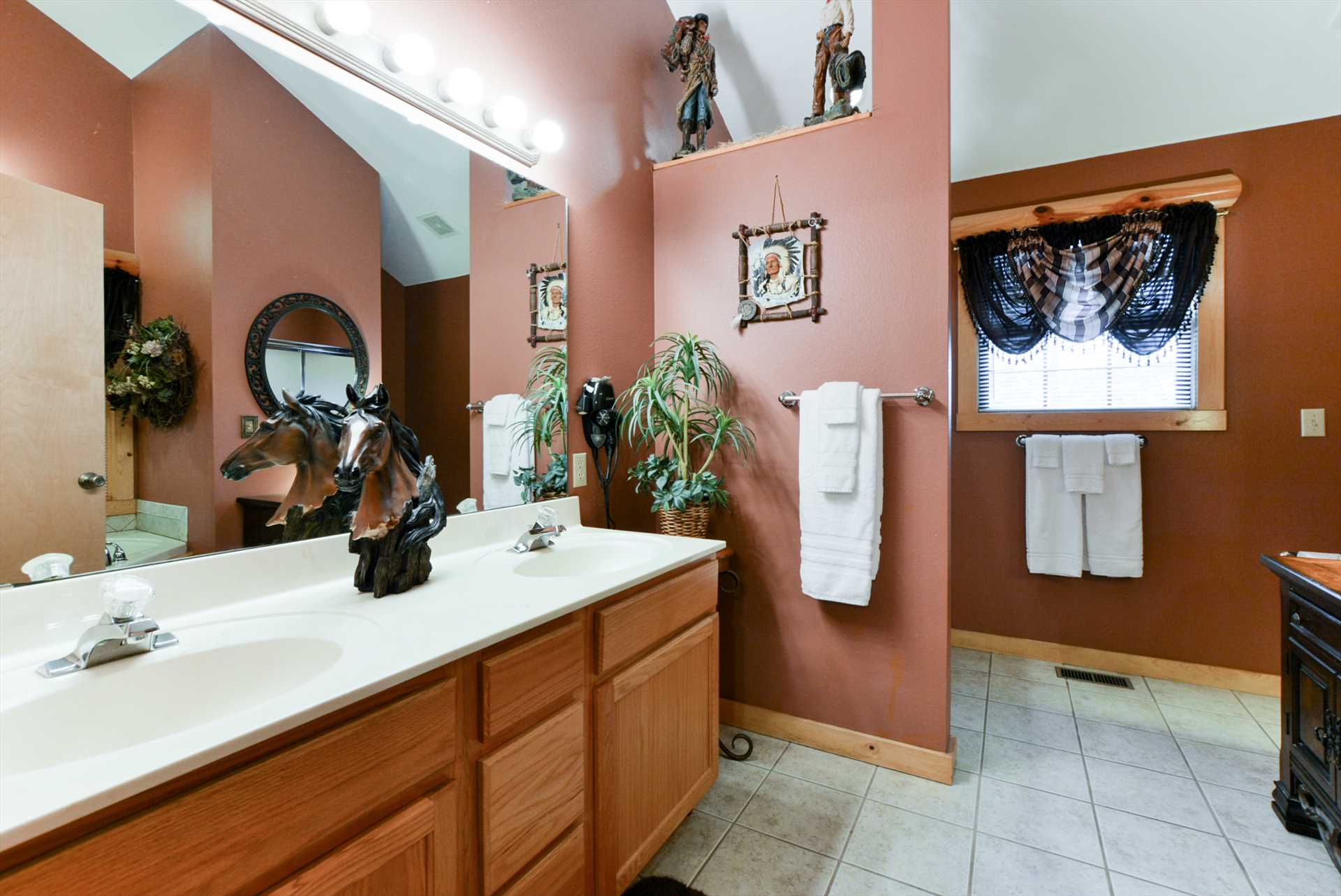 The spacious bathroom includes double vanities.