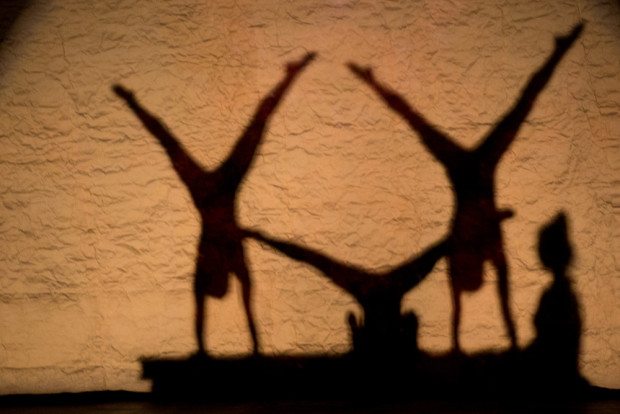shadows of acrobats performing