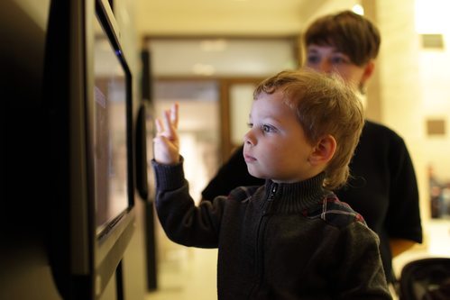 Mother and son playing with touch screen