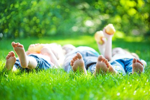Children laying on grass