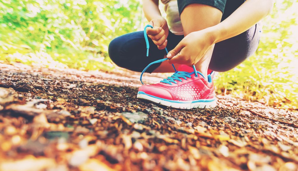 Female jogger tying her shoes