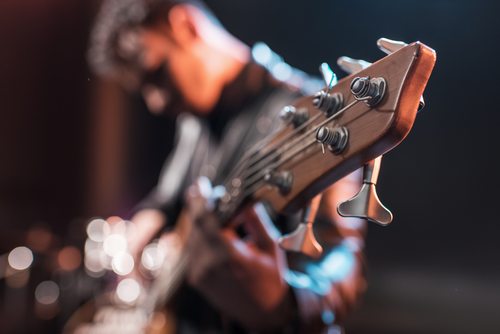 close up of guitar being played by a man