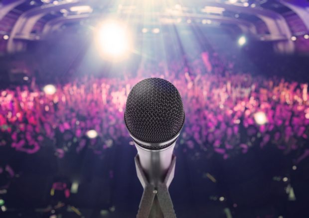 Microphone with an audience on the background