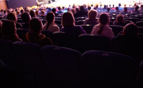 View of a seated concert audience from behind