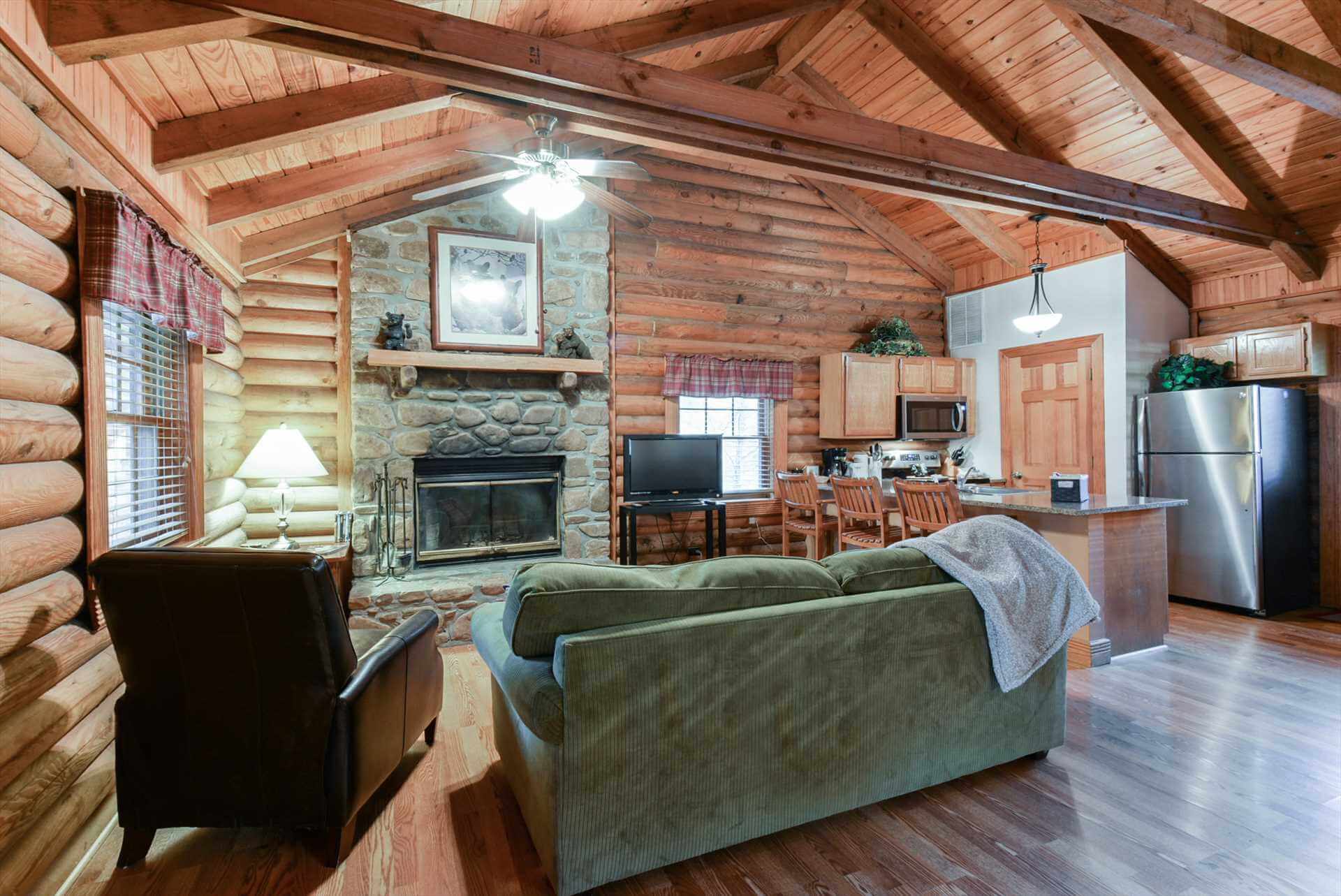 A photo of inside a Branson lodging location. This is a cabin living room furnished with sofas and chairs.