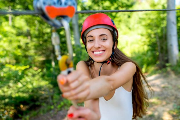 Photo of a Girl Holding a Zipline. Ziplining is One of the Best Branson Outdoor Activities.