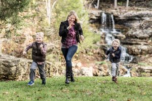 Photo of a Family Running inside Dogwood Canyon in Branson in the Fall.