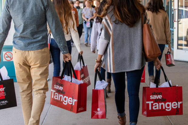 People with shopping bags Christmas shopping in Branson at Tanger Outlets