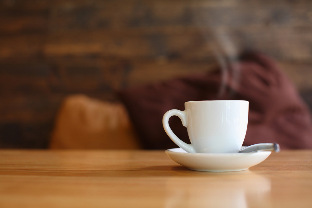 steaming cup of coffee on table