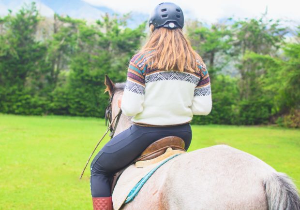 A woman horseback riding near Branson, MO.