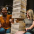 view of two women playing jenga with a drink in hand: indoor activities in Branson MO