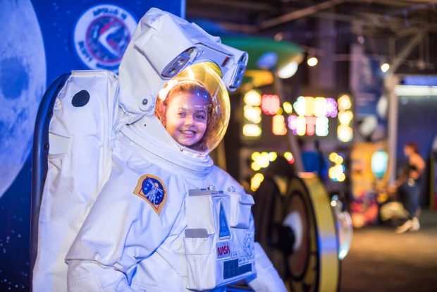 Photo of a Young Girl in the Astronaut Exhibit at WonderWorks, One of the Best Indoor Activities in Branson, MO.