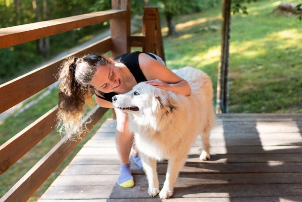A woman with her dog at one of the many pet friendly cabins in Missouri.