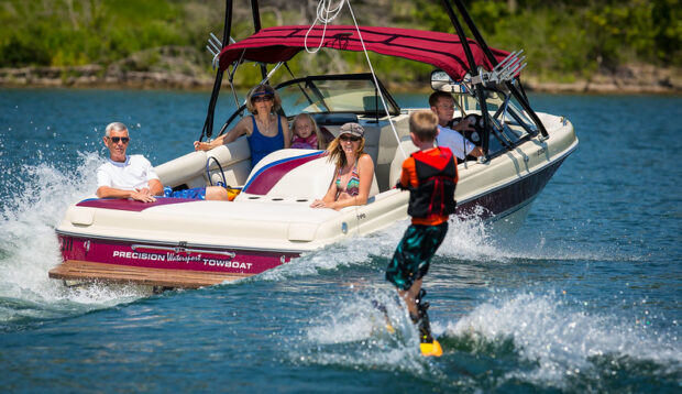 family hanging out on Table Rock Lake boat rental with water skier