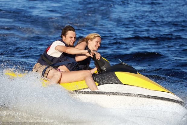 A man and a woman on a jet ski enjoying Branson, MO, Lakes.