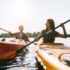 A man and a woman in a kayak enjoying Branson Fishing.